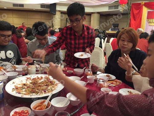 Preview: People sharing large meal at round table