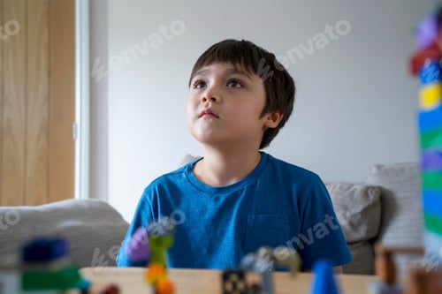 Preview: Portraits kid sitting on sofa looking up watching TV, Child watching cartoon on TV,boy stay at home