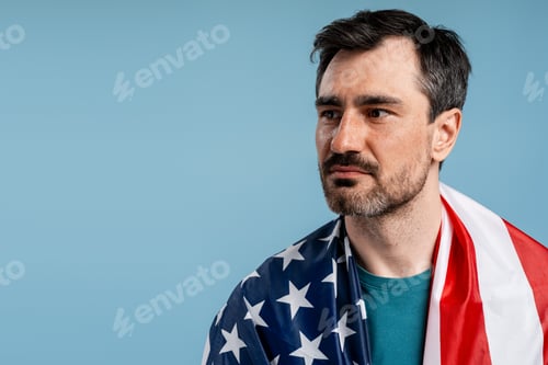 Preview: American man proudly draping the United States flag over his shoulders
