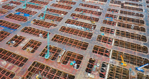 Preview: Busy industrial under construction site workers working and excavators. Top view of precast concrete