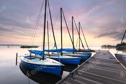 Preview: few yachts by pier at dawn