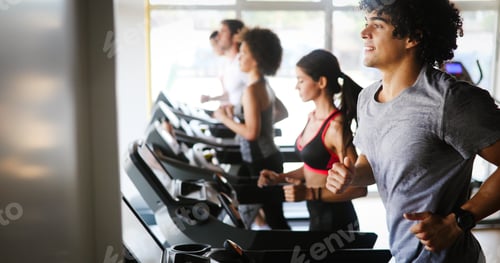 Preview: Group of fit healthy friends people cardio workout in gym