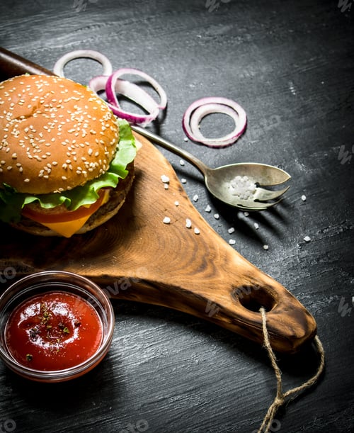 Preview: Cooked hamburger with ketchup and onion rings