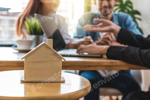 Preview: Closeup house model over the Sale representative offer the house price list