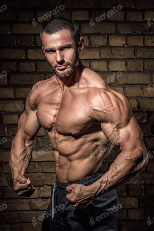 Preview: Man with muscular and sexy body against brick wall