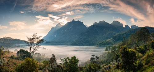 Preview: Sunrise over mountain range with foggy in tropical rainforest at national park