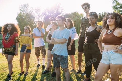 Preview: Group of friends posing under hot sun in park