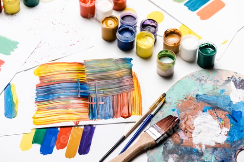 Preview: gouache paints, paintbrushes and abstract colorful brushstrokes on paper on white background