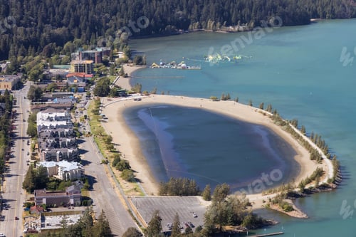 Preview: Small touristic town by the lake with Canadian Mountain Landscape.