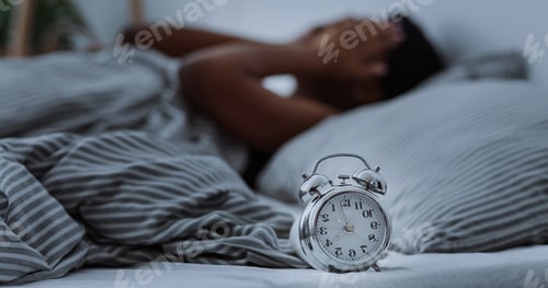 Preview: African american woman suffering from insomnia lying in bed without sleep.