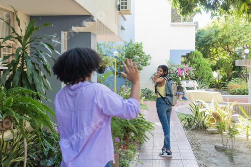 Preview: Mother and daughter waving goodbye for school day