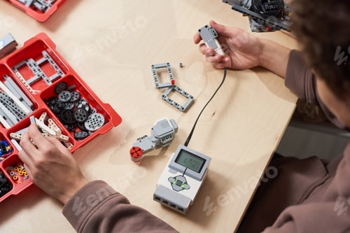 Preview: Teenager Building Robot in Class