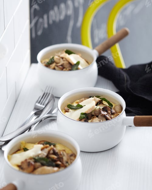 Preview: Gourmet mushroom risotto in white bowls on a table