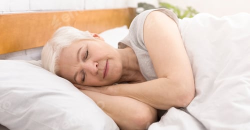 Preview: Senior woman sleeping in bed in morning