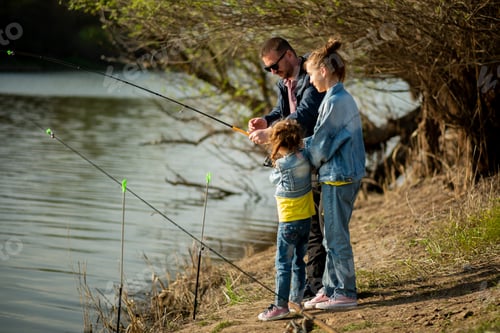 Preview: A dad and his two daughters are fishing in the river.