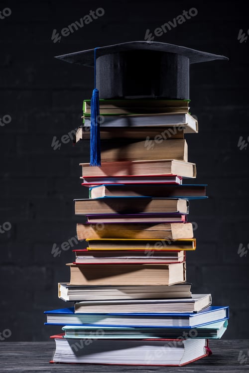 Preview: Graduation cap on tower of stacked books
