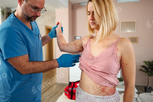Preview: Doctor examining woman with skin rash at home