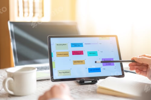 Preview: Businesswoman planning schedule with digital tablet and stylus