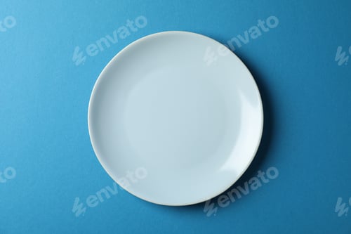 Preview: Plate on blue background, top view and space for text