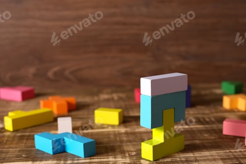 Preview: Multicolored puzzle, cubes on a wooden background