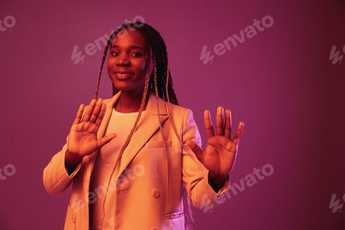 Preview: Woman african american business smile dancing party in neon light, colorful pink color, bright