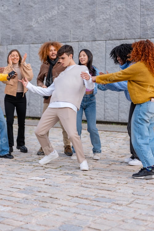 Preview: Youth dancing on street with friends cheering.