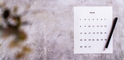 Preview: Calendar sheet for planning and pen on desktop top view web banner