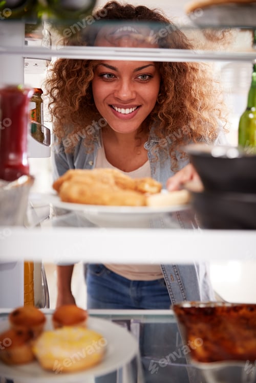 Preview: View Looking Out From Inside Of Refrigerator Filled With Takeaway Food As Woman Opens Door