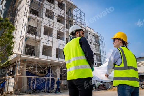 Preview: Engineer inspect building structure technicians looking at analyzing unfinished construction project