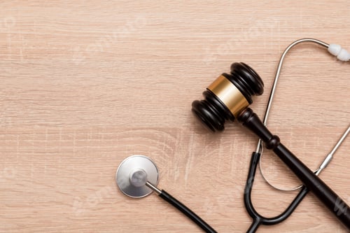 Preview: Judge gavel and stethoscope on wooden background, The law in medicine and medical negligence concept