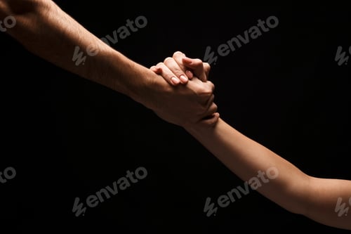 Preview: Hands of man and woman in love, isolated on black