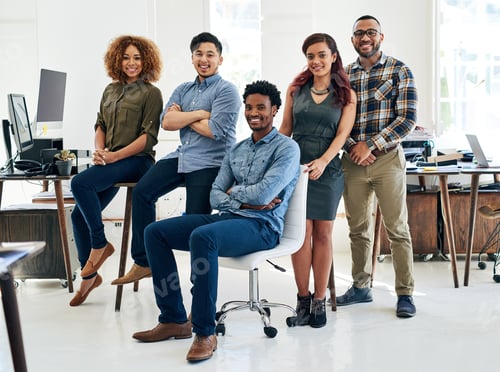 Preview: Portrait of a team of happy and confident colleagues working in a modern office