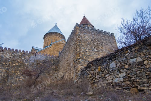 Preview: Ananuri castle complex under a cloudy sky in Georgia.