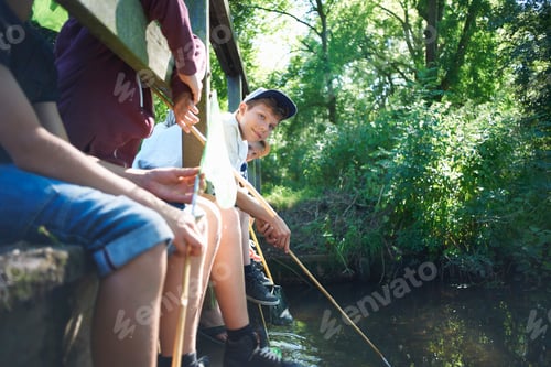 Preview: Boys sitting on bridge, fishing