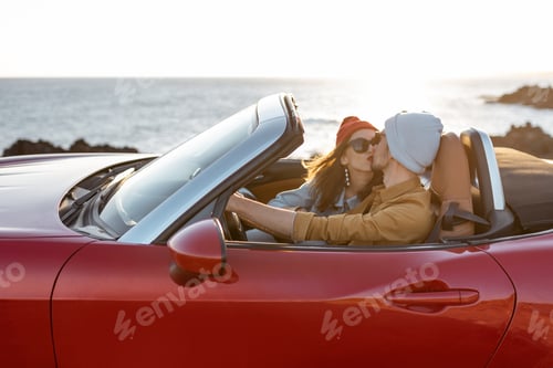 Preview: Lovely couple driving a cabriolet near the ocean
