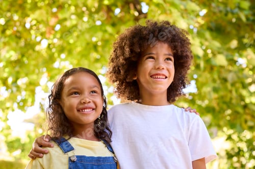 Preview: Portrait Of Boy And Girl Standing In Garden Smiling At Camera