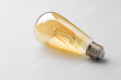 Preview: Light bulb on light grey paper background