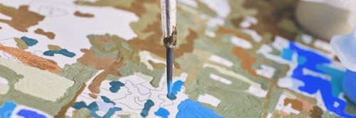 Preview: Close-up brush painting on canvas with detailed map of blue and green patterns