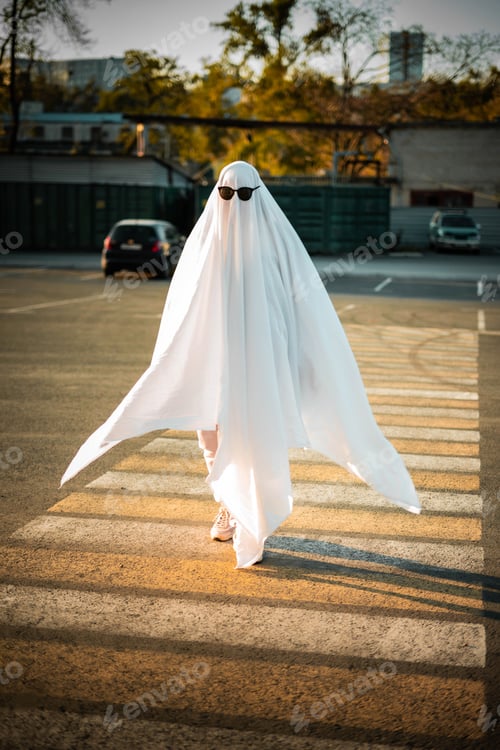 Preview: Celebrating halloween. Ghost Challenge 2021. Spooky trend season. A man dressed as a ghost from a sh