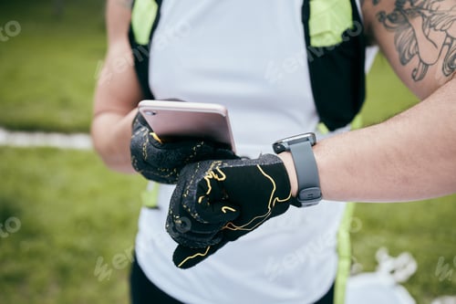 Preview: Cropped shot of an unrecognizable young male athlete checking the time during his morning run
