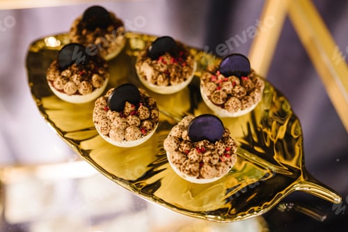Preview: Sweets. Candy bar with desserts for celebrating birthday, baptism, wedding. Desserts on a golden