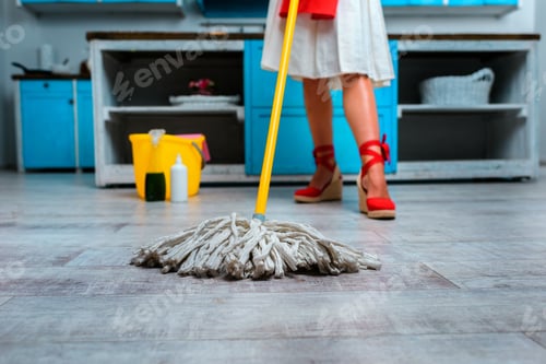 Preview: low section of housewife mopping floor in kitchen