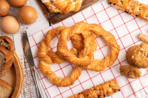 Preview: Various breads and eggs on red white cloth. Selective focus.