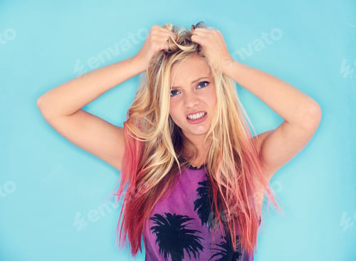 Preview: Thats so frustrating. A trendy young woman pulling her hair in frustration.