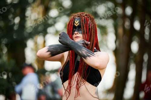 Preview: Mythological dancing girl faun on green lawn in public park outdoor art dancing event