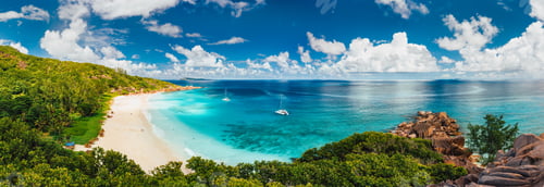 Preview: Aerial Pano of Grand Anse beach at La Digue island in Seychelles. White sandy beach with blue ocean