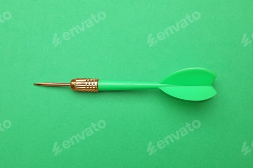 Preview: Plastic dart arrow on green background, top view