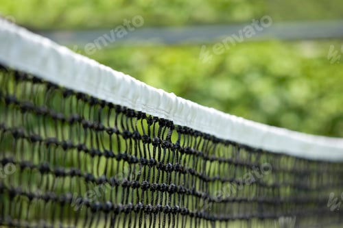 Preview: A young woman playing tennis, from behind