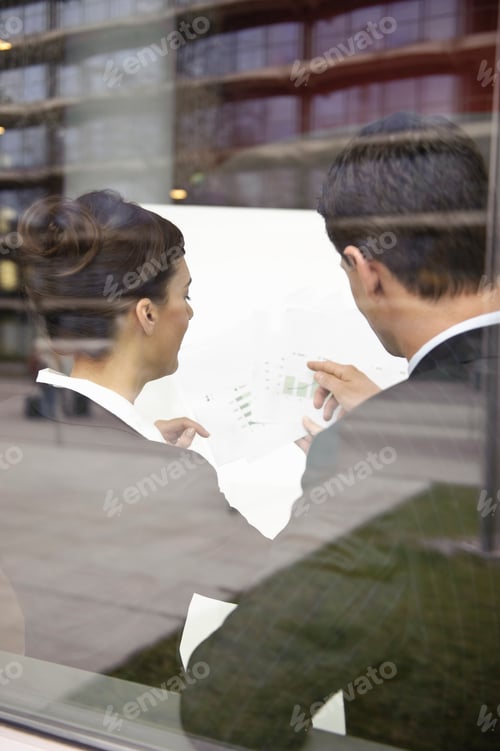 Preview: Business people looking at paperwork
