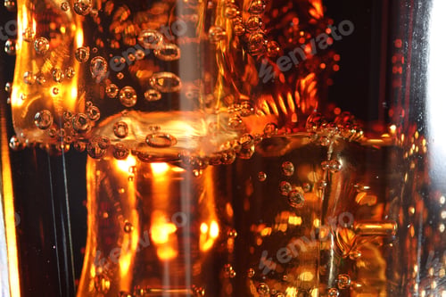 Preview: Refreshing cola with ice cubes as background, macro view